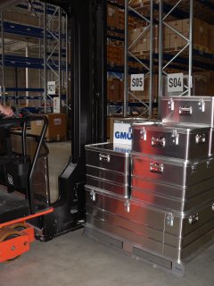 Transport containers and screwed welded pallets in high bay warehouse